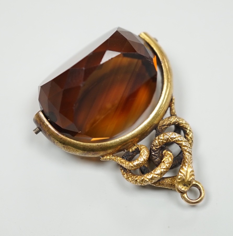 A late Victorian 15ct mounted citrine spinning fob seal, with serpent entwined bale, 34mm, gross weight 11.1 grams.